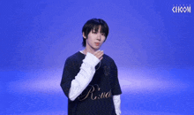 a young man wearing a black shirt with the word r.i.u.d. on it