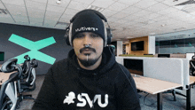 a man wearing headphones and a beanie that says multiverse