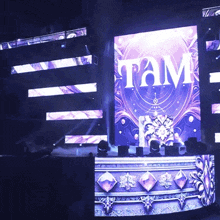 the word tam is on a large screen