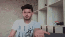 a man wearing a baseball cap and a t-shirt is making a funny face .