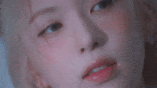a close up of a woman 's face with a braid in her hair