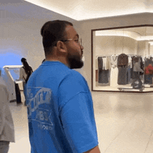 a man wearing a blue shirt that says ' no trick ' on it