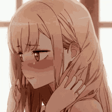 a close up of a girl 's face with a ring on her finger