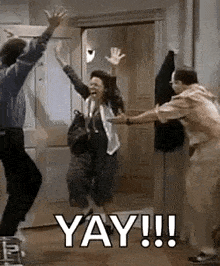 a group of people are jumping in the air in a room with the words `` yay !!! '' written on the bottom .