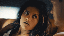 a woman with a surprised look on her face looks at the camera