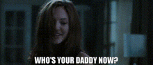 a woman in a dark room with the words who 's your daddy now on the bottom