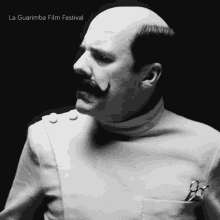 a black and white photo of a man with a mustache and scissors in his pocket sponsored by the la guarimba film festival