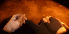 two hands are holding each other in front of a fire