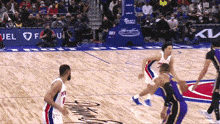 a basketball game is being played on a court sponsored by fuel of u.s.