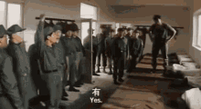 a group of soldiers are standing in a room in a military base .