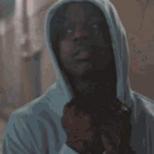 a close up of a person holding a bottle of beer in their hands .