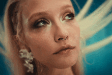 a close up of a woman 's face with a nose piercing