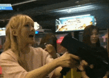 a woman is holding a gun in front of a sign that says pisode 2