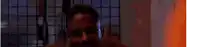 a man with a beard is holding a pair of scissors in front of his face .