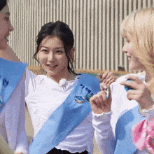 a girl wearing a sash that says " i love you " on it