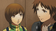 a boy and a girl are standing next to each other and the girl has the letter t on her shirt