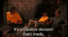 three men are sitting on a couch with the words it 's a creative decision that i made below them