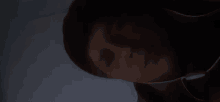 a close up of a person 's face in the dark .