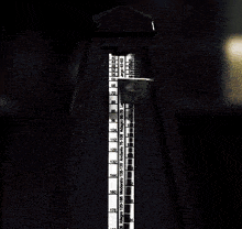 a black and white metronome with numbers from 1 to 144 on it