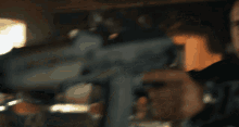 a blurred image of a man holding a gun
