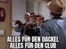 a group of men standing next to each other holding dachshunds and a police officer .