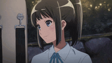 a girl with a blue bow in her hair is looking up