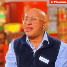 a bald man with glasses and a name tag that says dr pflaumisan on it