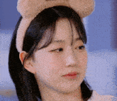 a close up of a woman wearing a headband with ears
