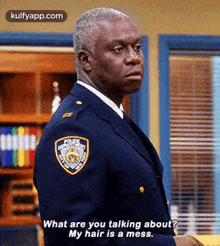 a man in a police uniform is talking to another man .