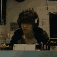 a man is sitting at a desk with a calendar on it .