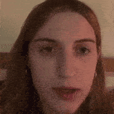 a close up of a woman 's face with earrings