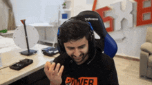 a man wearing headphones and a power shirt