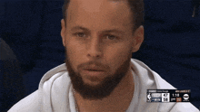 a man with a beard is watching a basketball game on tnt