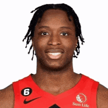 a basketball player wearing a red jersey with the number 6 on it is smiling for the camera .