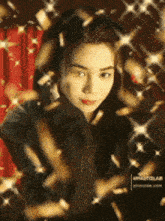 a woman in a black shirt is surrounded by glitter and confetti