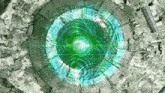 an aerial view of a space ship with a green light coming out of the center