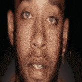 a close up of a man 's face with a beard and blue eyes