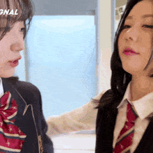 two girls are standing next to each other in front of a sign that says gnal on it
