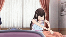 a girl sitting on a bed with a poster on the wall that says ' a '