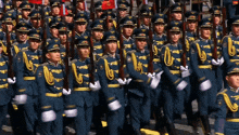 a large group of soldiers marching in a parade with the letter u on their uniforms