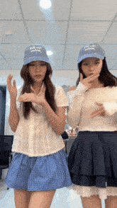 two girls wearing hats that say " just order " are dancing together