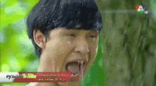 a man with his mouth open and water coming out of it is on a tv screen