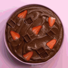 a bowl of chocolate pudding with strawberries and chocolate bars from hershey 's