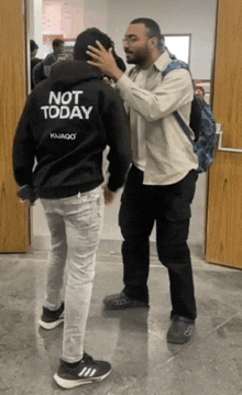a man wearing a black hoodie that says " not today "