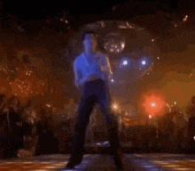 a man is dancing on a dance floor in front of a crowd .