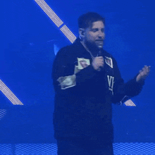 a man is wearing a black jacket that says down but not out
