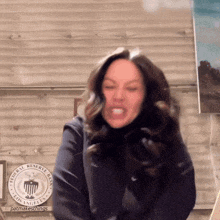 a woman is making a funny face in front of a sign that says federal reserve