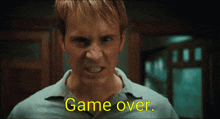 a close up of a man 's face with the words game over on the bottom