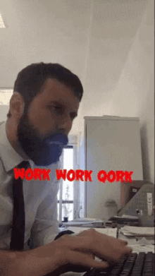 a man with a beard is typing on a keyboard and the words work work qork are visible