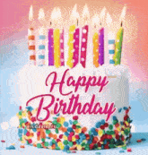 a birthday cake with candles and sprinkles on it .